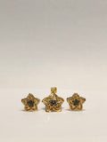 Gold star-shaped jewelry set on a light gray background